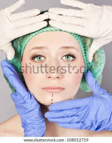 Plastic surgery touching the head of a beautiful female face