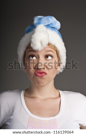 Christmas woman shocked. Woman with santa hat shocked and surprised. Funny image of beautiful young Caucasian model