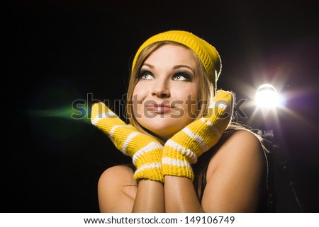Positive blond woman in hat and gloves