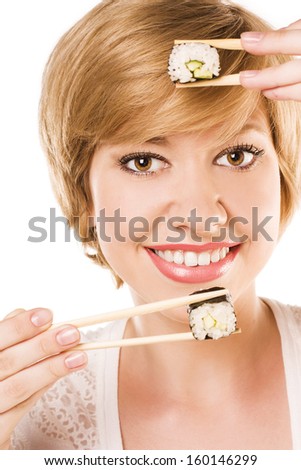 young woman eating a sushi. studio