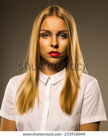 Portrait of casual dressed blond woman  over natural background