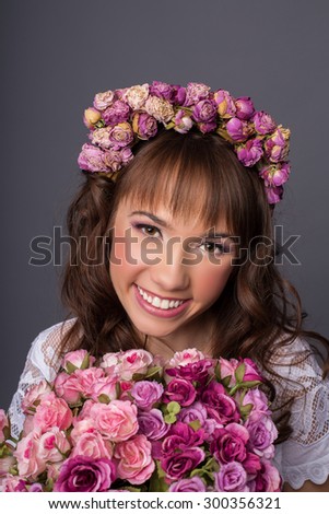 Young attractive bride with bouquet of flowers. Smiling beautiful young bride