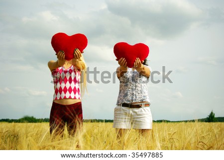 Two girls on the field with heart in hands