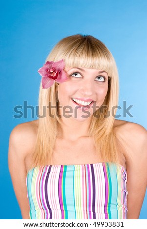 Lovely girl with a pink orchid in her hair