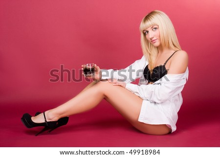 Sweet blonde in a white shirt with a red background