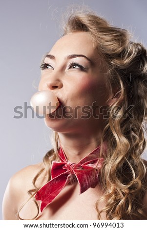 Pretty woman blowing bubble, with bubble gum