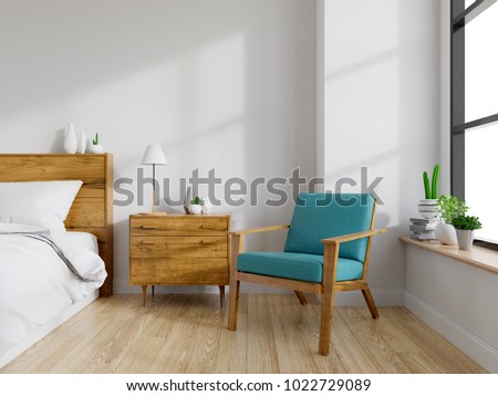 Modern Mid Century And Vintage Interior Of Bedroom Blue Lounge Chair With Wood Bedside Table And White Bed On White Wall And Wood Floor In Front Of A