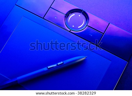 drawing tablet with pen in blue light closeup
