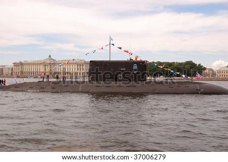 PETERSBURG - JULY 26: People stand on a submarine as it moves along the river Neva during a Russian naval fleet parade on July 26, 2009 in Saint-Petersburg, Russia.