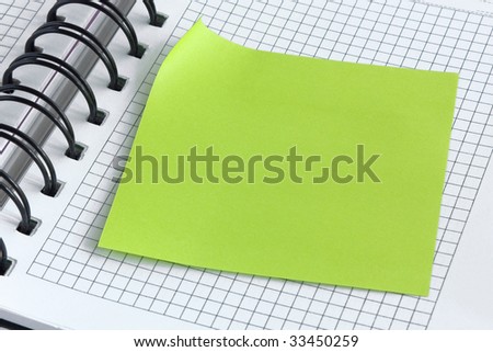 Notebook with blank page and with green sticker