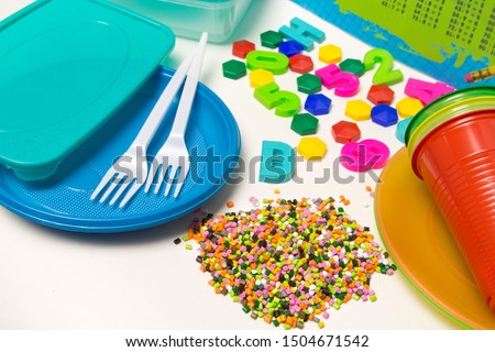Plastic granules disposable tableware and children's toys made of polyethylene, polypropylene, pet polymer material on a white background. BPA FREE Stock fotó © 