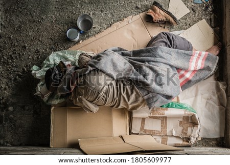 Similar – Foto Bild ein Obdachloser schläft im Eingang eines Plattenbaus in Berlin Mitte