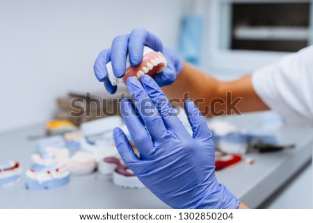 Similar – Image, Stock Photo Dentist working with denture in laboratory