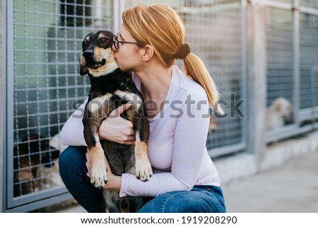 Similar – Image, Stock Photo Woman feeding dog in mountains