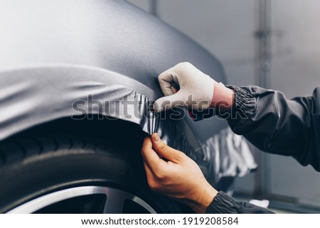 Similar – Image, Stock Photo Mechanic putting on protective mask in workshop