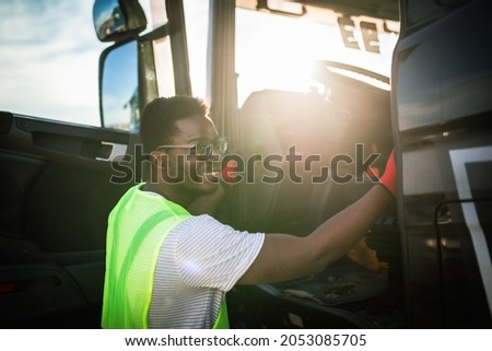 Young handsome African American man working in towing service and driving his truck. Сток-фото © 