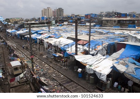 MUMBAI - AUGUST 21: Unidentified poor people living in slum at August 21, 2011 in Mumbai, India. According to 2010 census, 62% of Mumbai lives in slums.