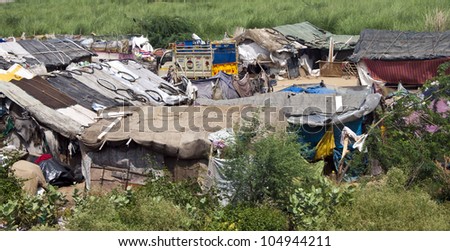 NEW DELHI, INDIA - AUGUST 3: Small slum near capital New Delhi on August 3, 2011 in India. Over 40 million Indian people live in slums.
