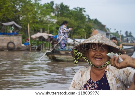 CAN THO, VIETNAM- JULY 24:Unidentified woman seller at a boat at Cai Rang Floating Market in Can Tho, Vietnam on July 24, 2012. Cai Rang Market is the biggest floating market in the Mekong Delta