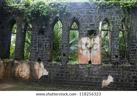 Ruin of abandoned church covered with roots on Ross Island. Andaman Islands, India