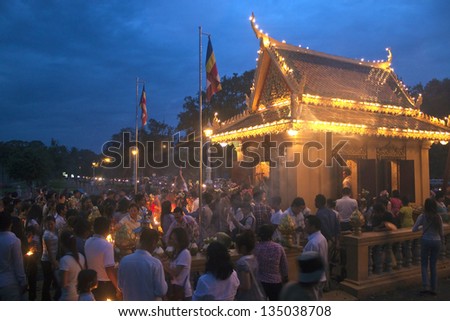 PNOM PENH, CAMBODIA - JULY 17: People at a religious ceremony in Pnom Penh, Cambodia on July 17, 2012. Pnom Penh is the capital and largest city of Cambodia.. Metropolitan area is home to 2.2 million.