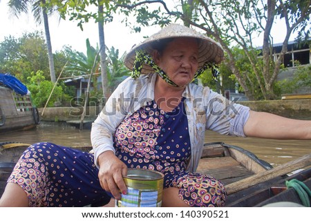 CAN THO, VIETNAM- JULY 24:Unidentified woman vendor at a boat at Cai Rang Floating Market in Can Tho, Vietnam on July 24, 2012. Cai Rang Market is the biggest floating market in the Mekong Delta