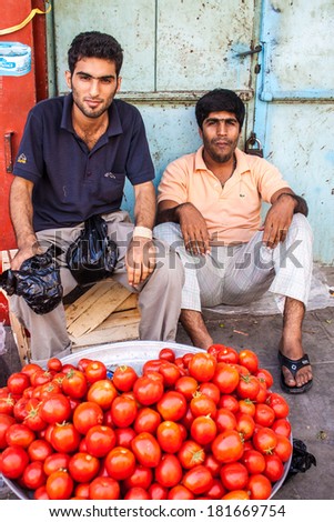 BANDAR ABBAS, IRAN - FEBRUARY 28: Men sell tomatoes at a market in Bandar Abbas, Iran on February 28, 2013. The city is a port which occupies a strategic position on the narrow Strait of Hormuz,