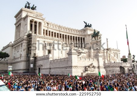 ROME, ITALY - JUNE 24: Crowd of football fans in front of Famous Italian monument Vittorio Emanuele II in Rome, Italy on June 24, 2014. They watch the match Italy-UrugUay of the Wolrd Cup.