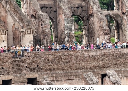 ROME - JUNE 25: Tourists visit Colosseum on June 25, 2014 in Rome, Italy. The Colosseum is one of Rome\'s most popular tourist attractions with over 5 million visitors per year.