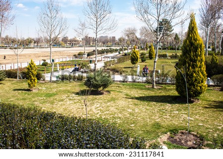 ISFAHAN, IRAN - MARCH 8: People enjoy a sunny day in a park in Isfahan, Iran on March 8, 2013. Isfahan has a population of 1,583,609 and is Iran\'s third largest city after Tehran and Mashhad.