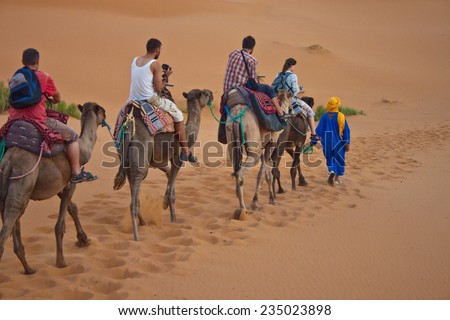 ERG CHEBBI, MOROCCO - AUGUST 4: Camel caravan with tourists in the desert on August 4, 2010 in Erg Chebbi, Morocco. Erg Chebbi is part of Sahara desert.