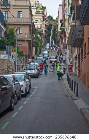 BARCELONA, SPAIN - AUGUST 16: Baixada de la Gloria street leading to famous Park Guell entrance on August 16, 2010 in Barcelona, Spain. It\'s one of the steepest streets in this city.