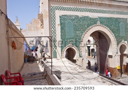 FES, MOROCCO - JULY 27: Old gate of medina on July 27, 2010 in Fes, Morocco. Fes center is listed in UNESCO and it is the largest preserved medieval city in the world. Also it\'s one big market.