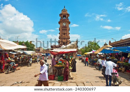 JODHPUR, INDIA - SEP 12: Unidentified locals shop at a market under the clock tower on Sep 12, 2011 in Jodhpur, India. City is popular tourist destination because of sights as Mehrangarh Fort.