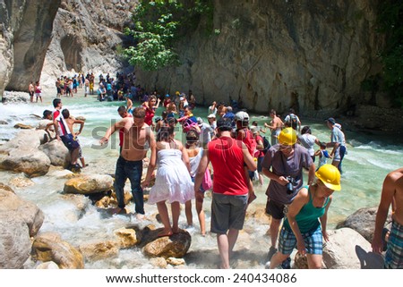 SAKLIKENT, TURKEY - JULY 27: Tourists walk in a canyon at July 27, 2011 in Saklikent, Turkey. Saklikent Canyon is located in southern Turkey. It is 300 meters deep and 18 km long.