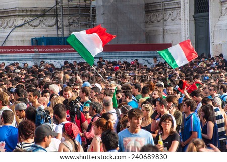 ROME, ITALY - JUNE 24: Crowd of football fans in front of Famous Italian monument Vittorio Emanuele II in Rome, Italy on June 24, 2014. They watch the match Italy-Urugiay of the World Cup.