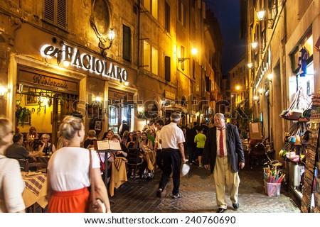 ROME - JUNE 24: People eat in street restaurants on June 24, 2014 in Rome, Italy. According to Euromonitor, Rome is the 3rd most visited city in Europe (5.5m international tourist arrivals 2009).