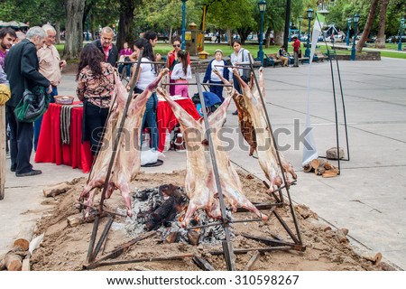 MENDOZA, ARGENTINA - MARCH 30, 2015: Traditional asado - barbecue of a lamb. Plaza Independecia square in Mendoza, Argentina.