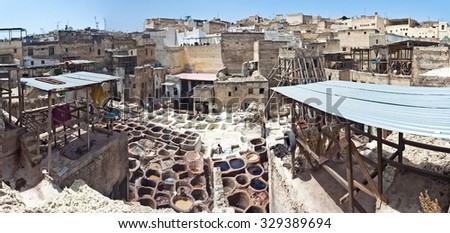 FEZ, MOROCCO - JULY 27: Workers in the tannery souk of weavers on July 27, 2010 in Fez, Morocco. The tannery souk of weavers is the most visited part of the 2000 years old city.