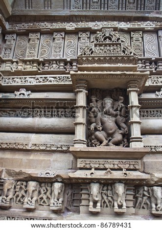 Detail of carving on a temple in Khajuraho, Madhya Pradesh, India. God Ganesh in the centre.