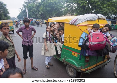 AHMEDABAD, INDIA - SEPTEMBER 7: Unidentified children travel from a school by a rickshaw at September 7, 2011 in Ahmedabad, India. Education is free for children for 6 to 14 years of age in India.