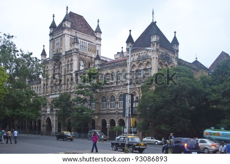 MUMBAI, INDIA - AUGUST 21: Traffic on a street on August 21, 2011 in Mumbai, India. The architecture of Mumbai blends Gothic, Victorian, Art Deco and Indo-Saracenic architectural styles.