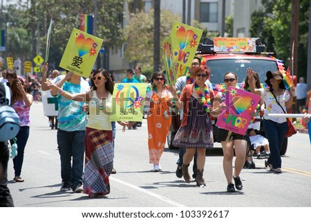 LONG BEACH - MAY 20: Activists holding peace and love signs in different languages during the Long Beach Lesbian and Gay Pride Parade 2012 on May 20, 2012 in Long Beach, California.