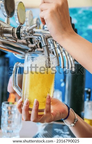 Similar – Foto Bild Kellnerin zapft Zapfhahn-Bier in einer Bar