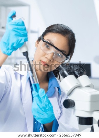 Similar – Image, Stock Photo Focused scientist examining chemical solution in laboratory