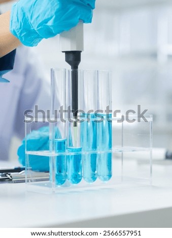 Similar – Image, Stock Photo Focused scientist examining chemical solution in laboratory