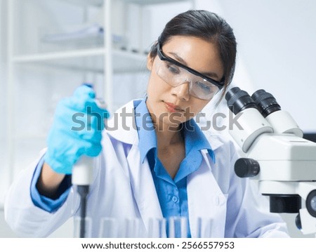 Similar – Image, Stock Photo Focused scientist examining chemical solution in laboratory