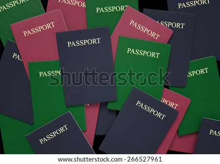 Travel and customs concept of passport books in blue, green, and red