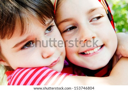 Two sisters hug and squeeze each other - Stock Image - Everypixel