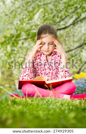 Young girl learning outdoor - spring time